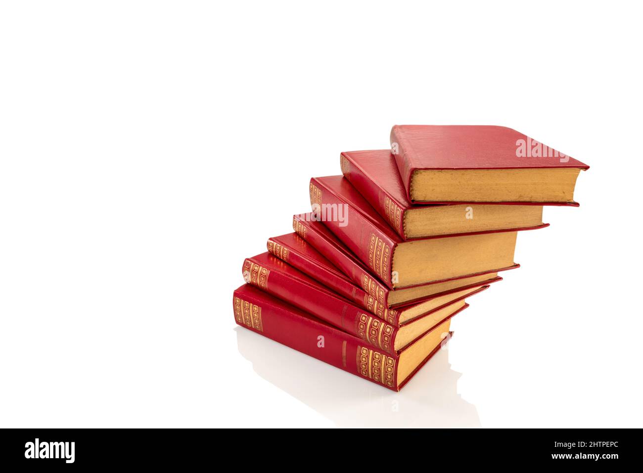 Stapel von roten Vintage-Büchern mit goldenen Verzierungen auf Hartledereinband, isoliert auf weißem, Schneideweg, Kopierraum Stockfoto