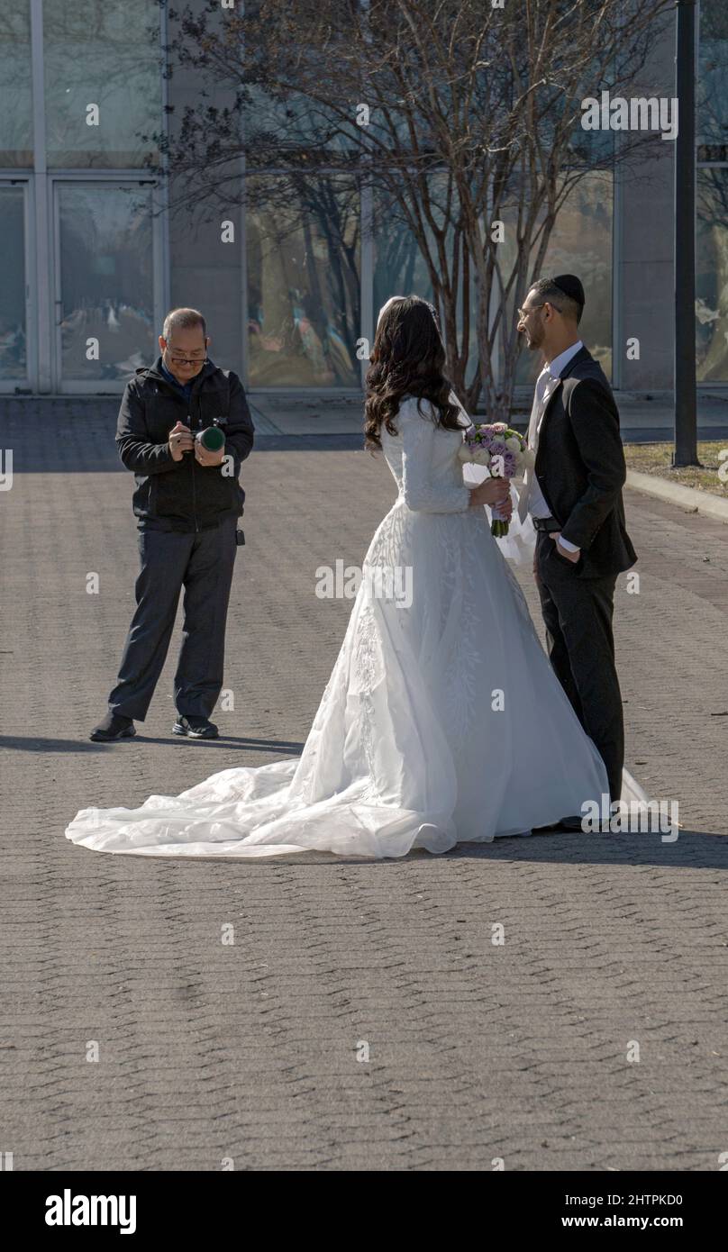 Ein orthodoxes jüdisches Paar posiert an einem milden Wintertag in einem Park in Queens, New York, für Hochzeitsfotos. Stockfoto