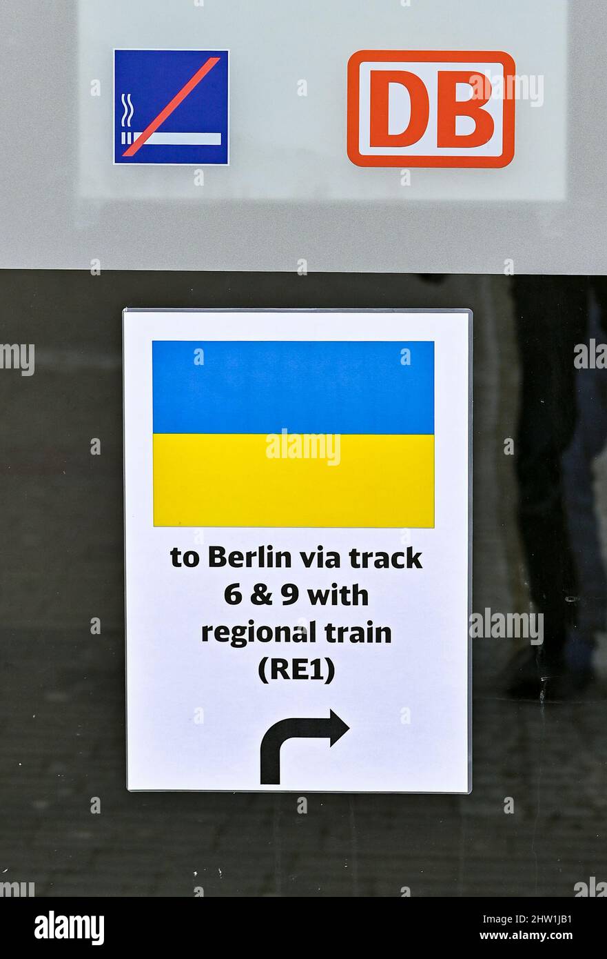 03. März 2022, Brandenburg, Frankfurt (oder): Auf einem Schild an der Tür zum Bahnhof Frankfurt (oder) ist die Flagge der Ukraine und die Aufschrift "nach Berlin über die Gleise 6 & 9 mit Regionalzug (RE1)" zu sehen. Züge aus Polen mit Kriegsflüchtlingen werden am Bahnhof erwartet. Foto: Patrick Pleul/dpa-Zentralbild/dpa Stockfoto