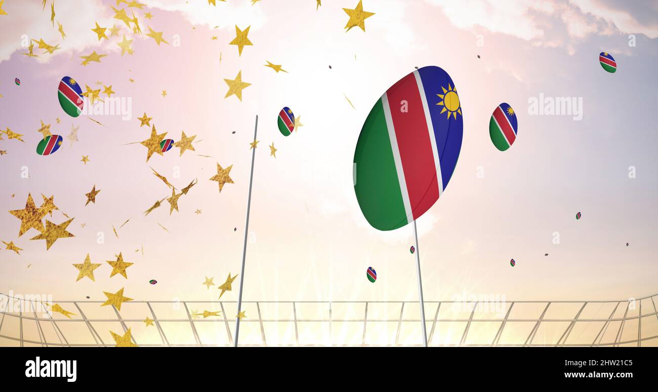 Bild von Sternen über Rugby-Kugeln, gefärbt mit namibia-Flagge, die im Stadion fällt Stockfoto