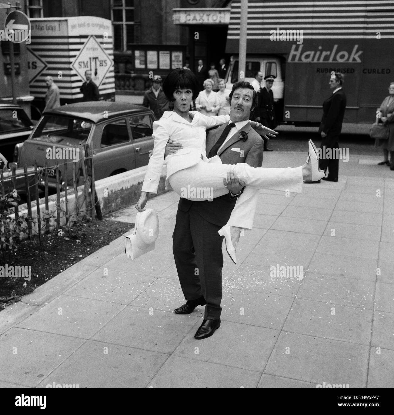 Als der Schauspieler Robin Hunter heute in der Caxton Hall heiratete, trug seine Schauspielerin Braut Amanda Barrie ebenfalls einen Anzug. Ihre war in weißem Leinen mit einem weißen passenden Hut. Amanda sagte scherzhaft: „Aber Robin wird die Hose in unserer Ehe tragen.“ 19.. Juni 1967. Stockfoto