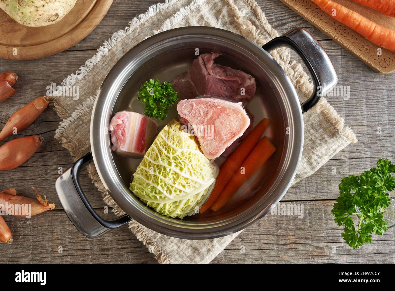 Zutaten für Brühe oder Suppe in einem Topf - Knochen, Rindfleisch und Gemüse, Draufsicht Stockfoto