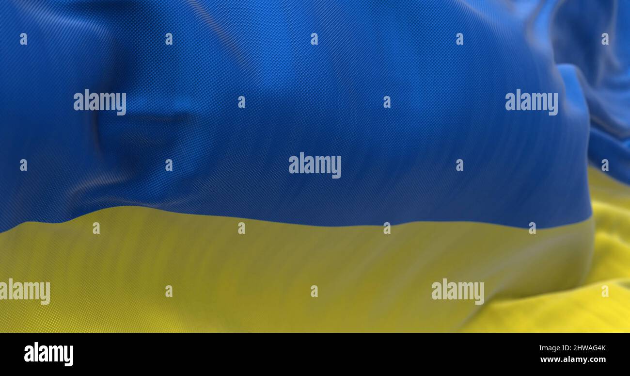 Detail der im Wind winkenden Nationalflagge der Ukraine. Demokratie und Politik. Patriotismus. Selektiver Fokus. Nahtlose Zeitlupe Stockfoto
