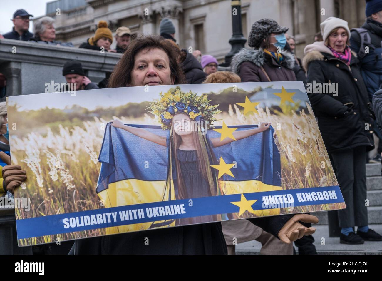 London, Großbritannien. 5. März 2022. Frau hält ein Solidaritätsposter. Ukrainer und Anhänger eines Protestes der Ukraine Solidarity Campaign auf dem Trafalgar Square stehen in Solidarität mit den Menschen in der Ukraine, die sich der russischen Invasion widersetzen und den Russen, die wegen ihres Widerstands gegen den Krieg verhaftet werden. Sie fordern von der britischen Regierung, dass diejenigen, die vor dem Krieg nach Großbritannien fliehen, unverzüglich zulassen. Peter Marshall/Alamy Live News Stockfoto