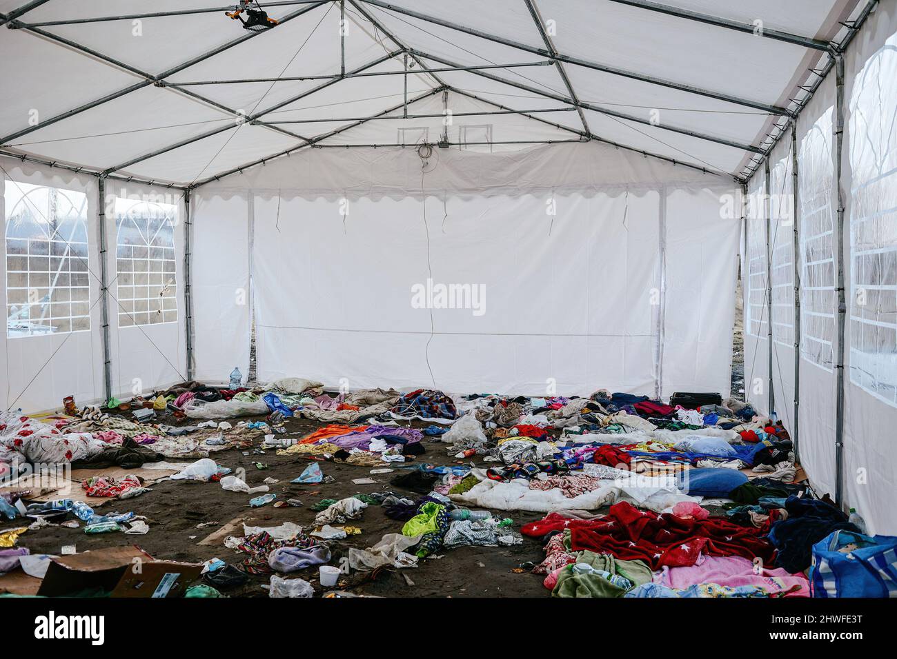 Medyka, Karpatenland, Polen. 3. März 2022. Kleidung und Decken, die Flüchtlinge in einem provisorischen Zelt an der Grenze zurückgelassen haben.Grenzübergang zwischen Polen und der Ukraine in Medyka. Seit Beginn der russischen Invasion in der Ukraine sind rund 700.000 Menschen nach Polen geflohen, um dem Krieg zu entkommen. Trotz erheblicher Fehlinformationen und isolierter Vorfälle werden ukrainische Flüchtlinge mit Empathie, Hilfe und Verständnis begrüßt, aber viele humanitäre Experten deuten darauf hin, dass bei einem so großen Zustrom von Menschen in wenigen Wochen eine Krise eintreten könnte. (Bild: © Filip Radwanski/SOPA Bilder via ZUMA Press W Stockfoto