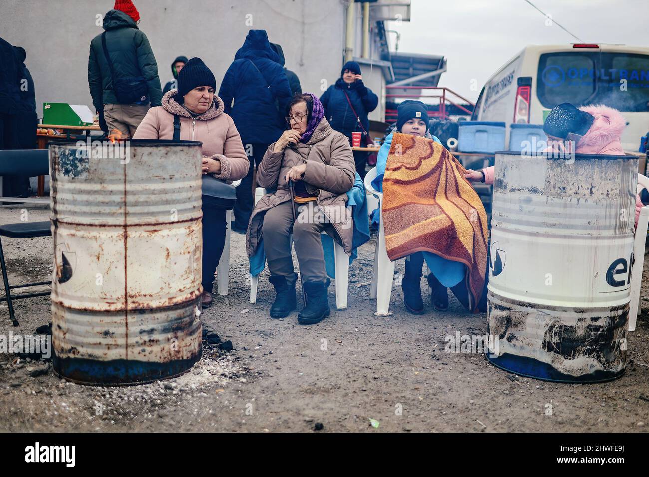 Medyka, Karpatenland, Polen. 3. März 2022. Ukrainische Flüchtlinge wärmen sich mit provisorischen Heizungen auf.Polnisch-ukrainischer Grenzübergang in Medyka. Seit Beginn der russischen Invasion in der Ukraine sind rund 700.000 Menschen nach Polen geflohen, um dem Krieg zu entkommen. Trotz erheblicher Fehlinformationen und isolierter Vorfälle werden ukrainische Flüchtlinge mit Empathie, Hilfe und Verständnis begrüßt, aber viele humanitäre Experten deuten darauf hin, dass bei einem so großen Zustrom von Menschen in wenigen Wochen eine Krise eintreten könnte. (Bild: © Filip Radwanski/SOPA Images via ZUMA Press Wire) Stockfoto