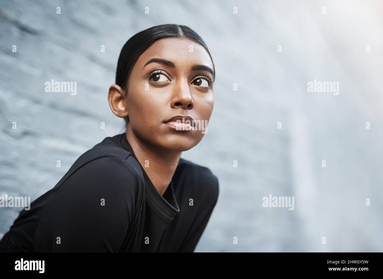 Lassen Sie sich nie davon abhalten, Ihre Fitnessziele zu verfolgen. Aufnahme einer jungen Frau, die sich auf das Training im Freien vorbereitet. Stockfoto