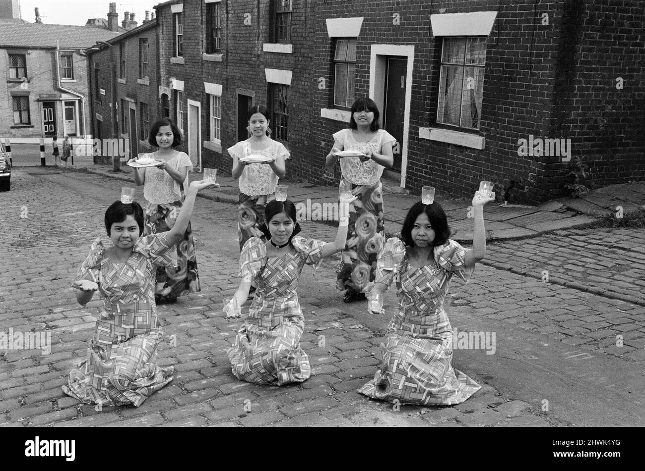 Frauen aus Manila, die in einer Mühle in Rochdale, Lancashire, arbeiten, zeigen in den Kopfsteinpflasterstraßen von Rochdale nationale Tänze. 20.. Juli 1972. Stockfoto