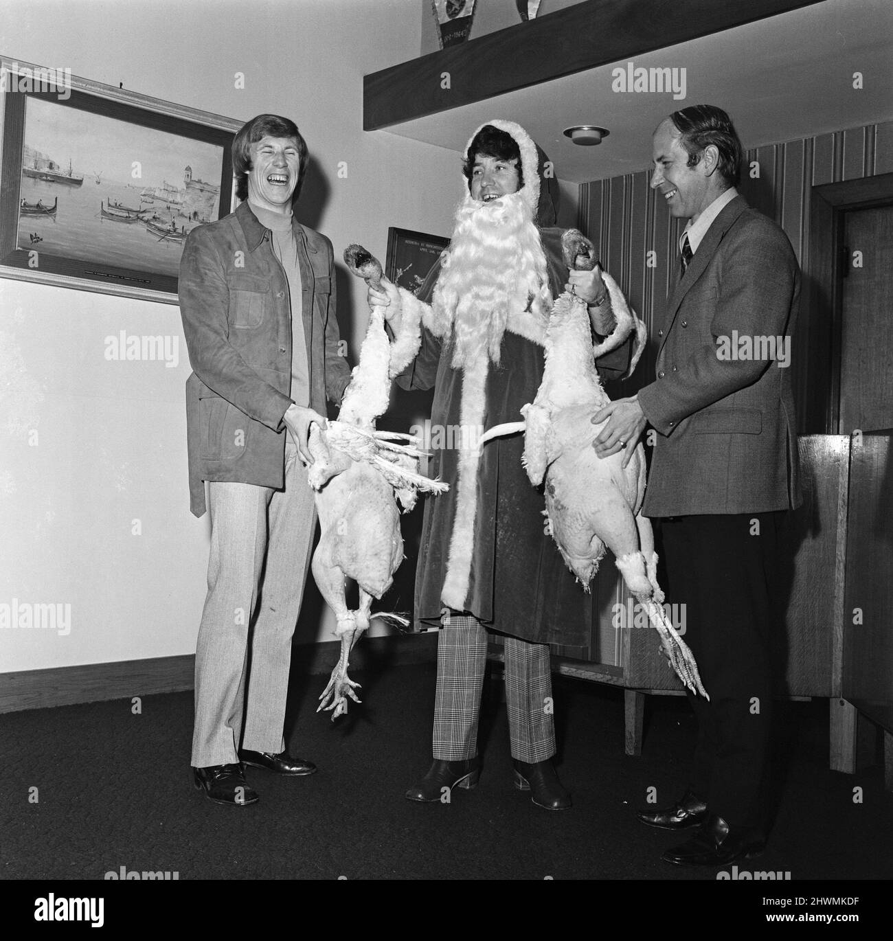 Colin Bell, Jimmy Tarbuck und Bobby Charlton posieren mit einigen Truthäuten. 23.. Dezember 1971. Stockfoto