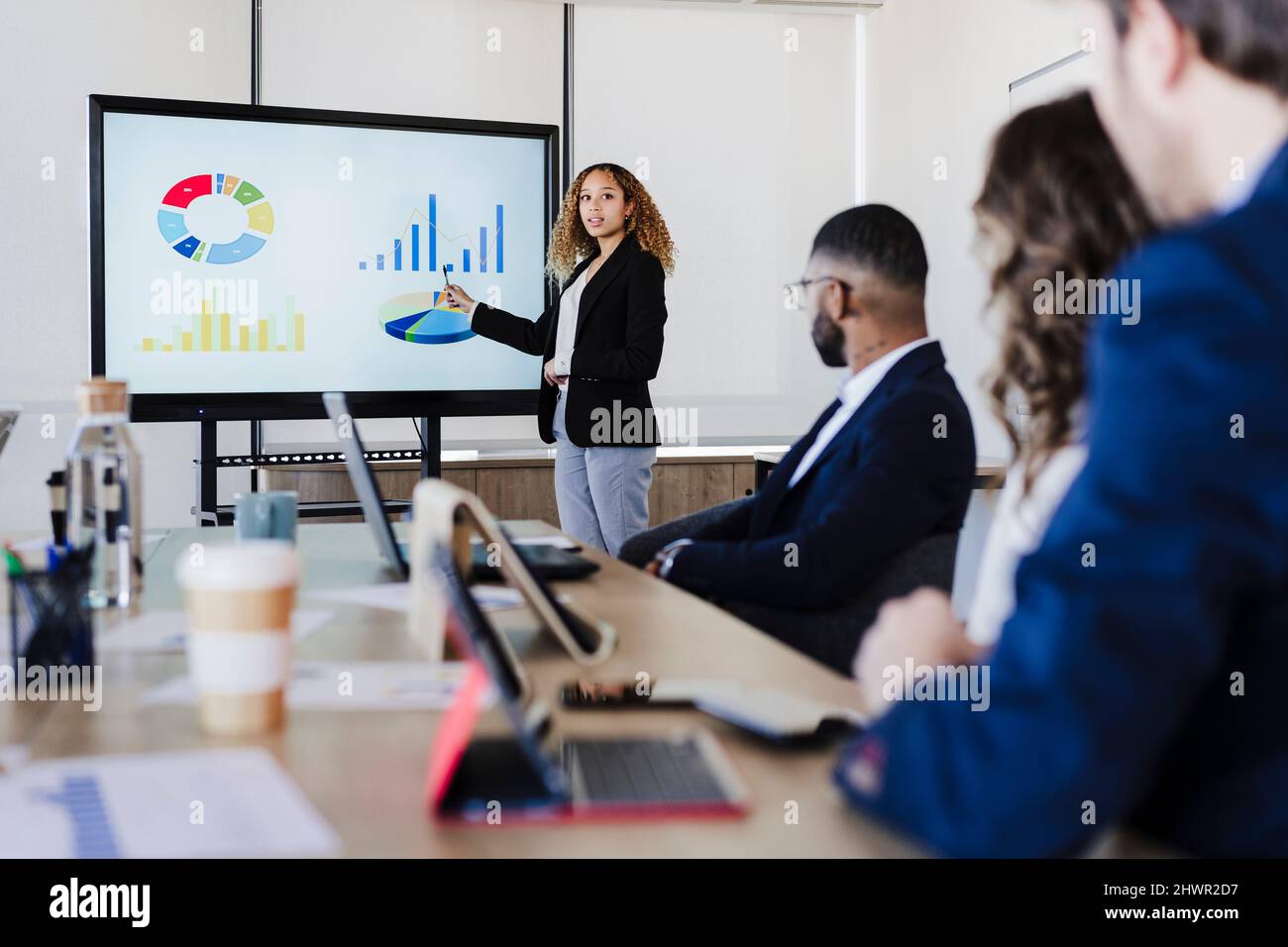 Kollege erklärt Managern im Coworking-Büro Diagramme Stockfoto