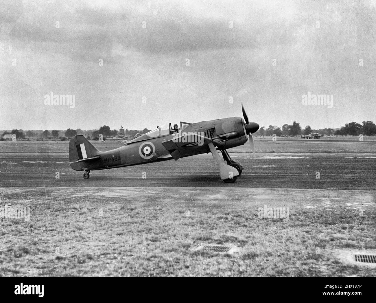 Eine gefangene Focke Wulf FW 190A-3 im Royal Aircraft Establishment, Farnborough, mit dem Haupttestpiloten der RAE, Wing Commander H J 'Willie' Wilson, bei den Kontrollen, August 1942. Die FW Focke Wulf wurde 190A-3, MP499 gefangen und besteuert im Royal Aircraft Establishment, Farnborough, Hampshire, mit dem Haupttestpiloten der RAE, Wing Commander H J 'Willie' Wilson an den Kontrollen. Obwohl sie am 1942. Juli MP499 formell an die Air Fighting Development Unit übertragen wurde, wurde sie von der RAE übernommen und wurde von fliegenden und technischen Mitarbeitern umfassend evaluiert, einschließlich eines Programms von Versuchen mit der zeitgenössischen Al Stockfoto