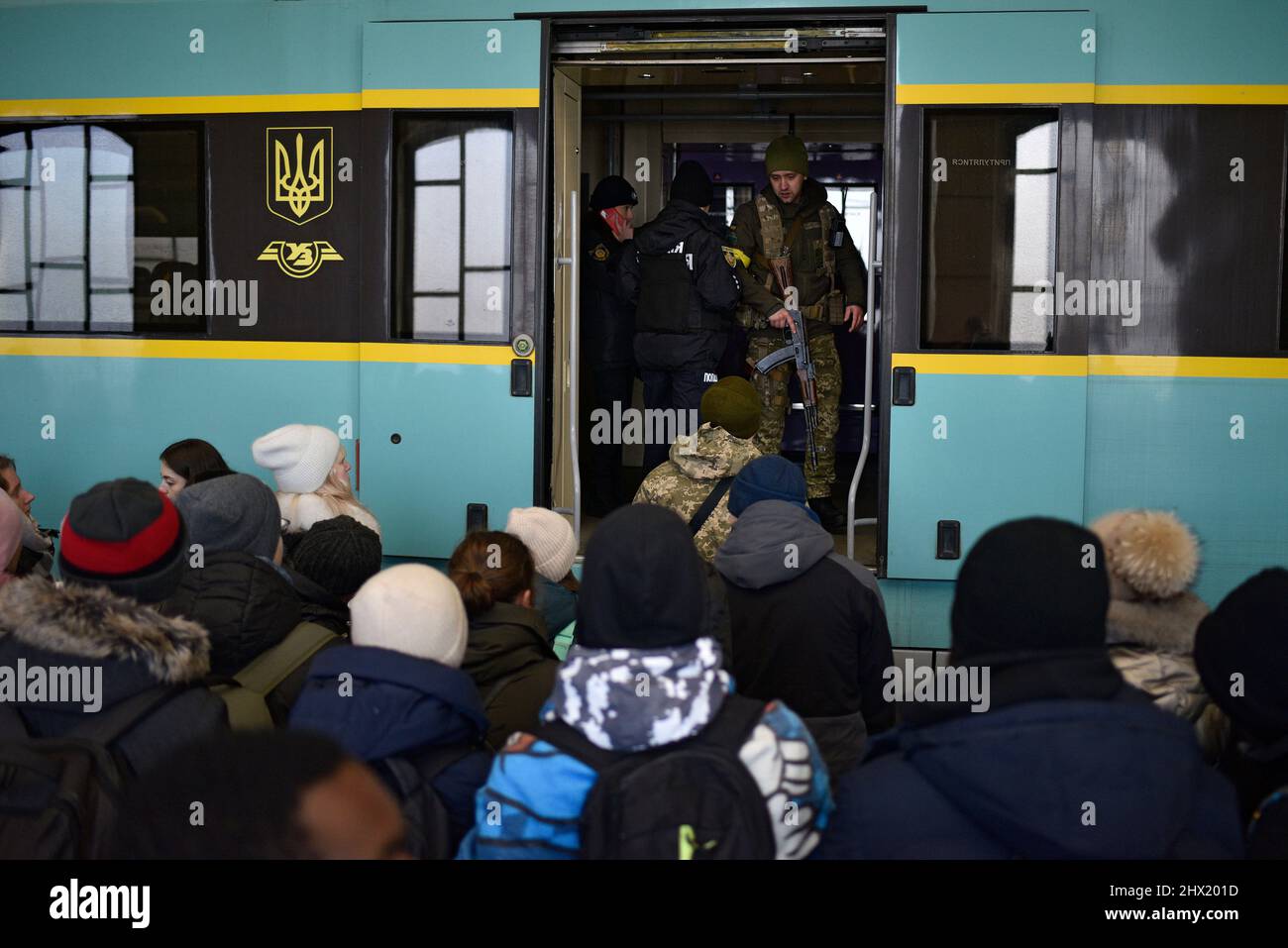 LVIV, UKRAINE - 28. FEBRUAR 2022 - Menschen, die vor Feindseligkeiten fliehen, steigen in einen Evakuierungszug nach Polen am Bahnhof von Lviv, Lviv, Westukraine. Stockfoto