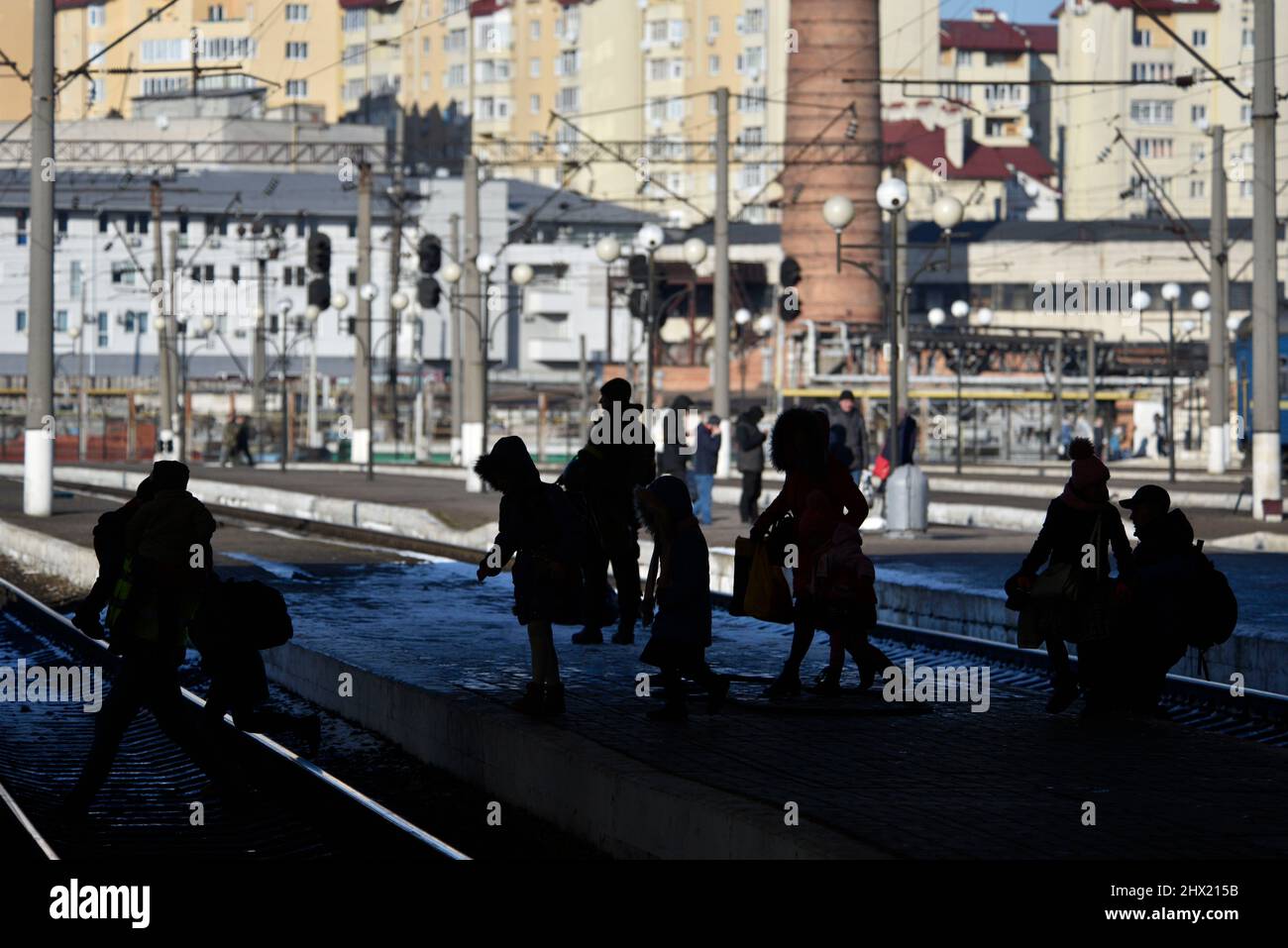 LVIV, UKRAINE - 28. FEBRUAR 2022 - die Silhouetten von Menschen werden am Bahnhof von Lviv als Flüchtlinge vor Feindseligkeiten an Bord Evakuierung tr gesehen Stockfoto