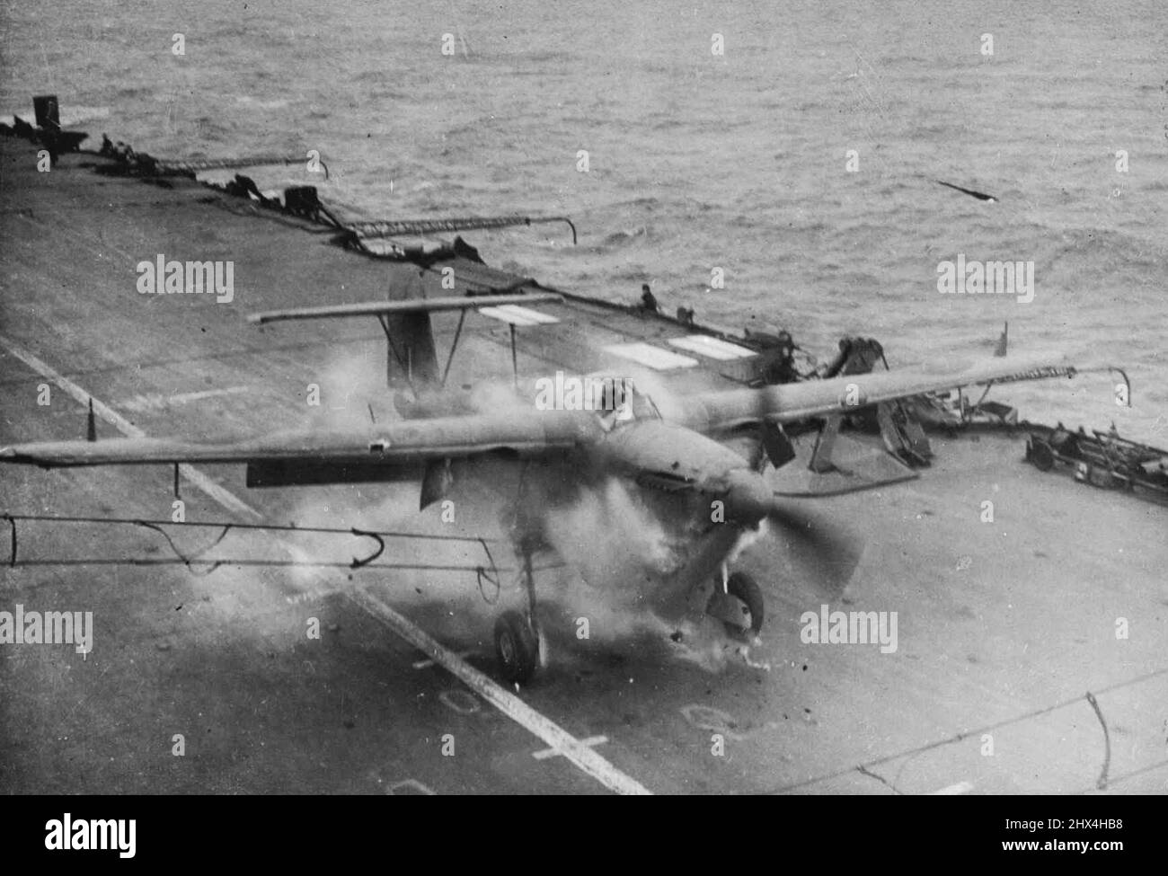 Der Fleet Air Arm trifft den 'Tirpitz' - Eine 'Barraouda' landet schlecht und trifft die Crashbarriere. Teile des Propellors können in der Luft fliegen gesehen werden. Niemand wurde verletzt. An Bord eines R. Naval-Flugzeugträgers während einer weiteren erfolgreichen Flottenflugarm-Aktion gegen das Gorman-Schlachtschiff „Tirpitz“ und die feindliche Schifffahrt vor Norwegen. 11. September 1944. (Foto von British Official Photograph). Stockfoto