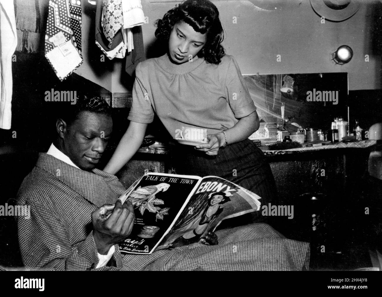 Mit seiner Verlobten Marie Ellington liest Cole Berichte über seine Hochzeitspläne. 23. September 1948. (Foto: France Media Agency). Stockfoto