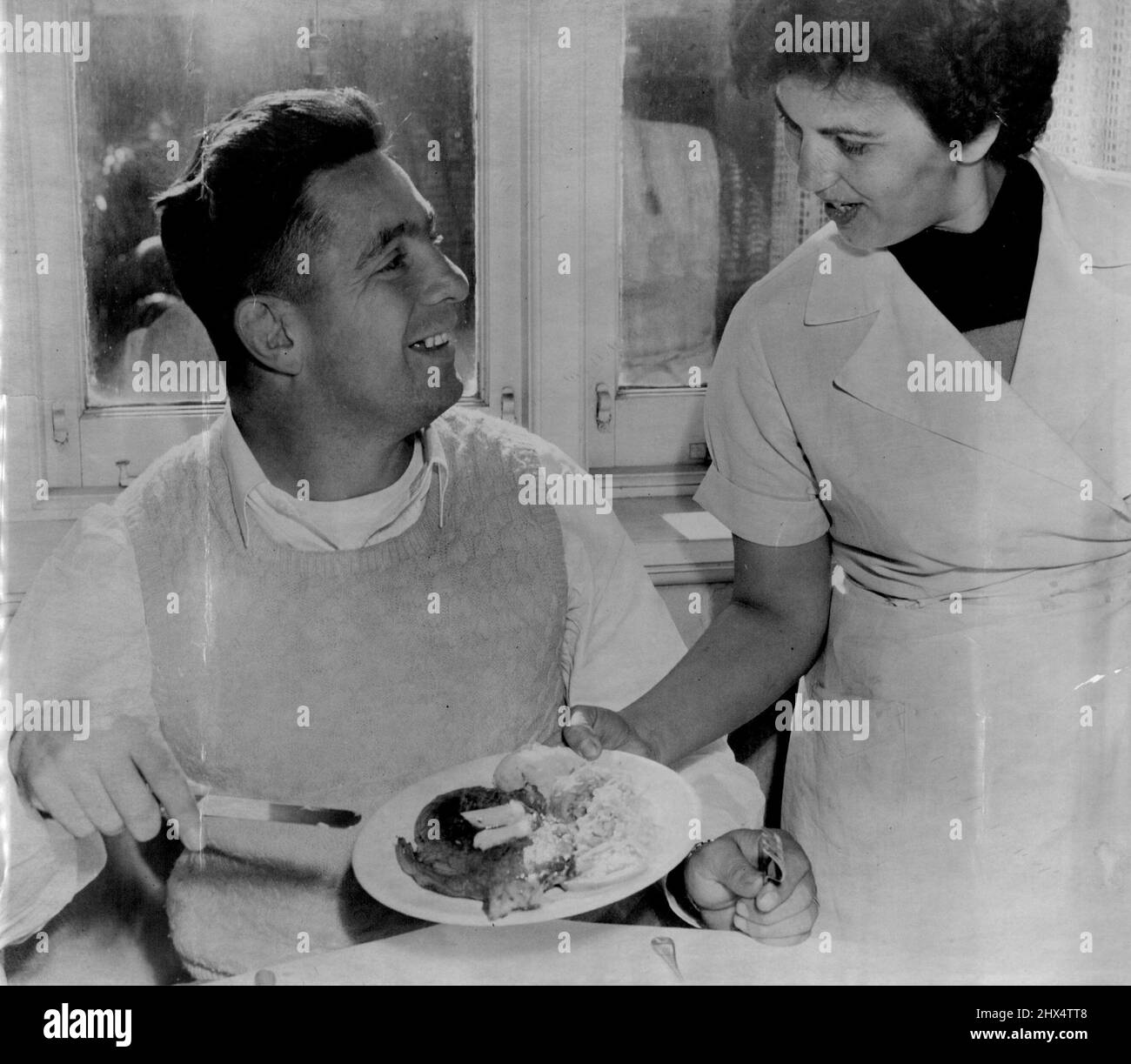 Vor dem England-Australien-Test heute, in dem sein Team untergebracht war, serviert Duncan Hall, Australiens erste Reihe nach vorne, ein Mittagessen auf einem großen Steak mit Salat im Hotel in North Sydney. 12. Juni 1954. Stockfoto