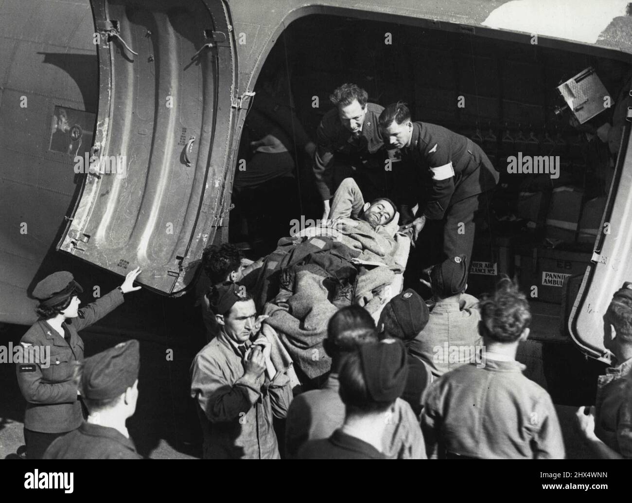 W.A.F.S. Fliegen Sie mit Verwundeten aus Frankreich -- Allgemeine Ansicht der Tragbahre, die entladen werden, bei der Ankunft in England. Die ersten britischen Verwundeten, die vom Schlachtfeld in der Normandie aus der Luft evakuiert wurden, kamen gestern Abend auf einem geheimen Flugplatz an. Drei W.A.A.F., Krankenpflegerorderlies, flogen in den Flugzeugen aus und begleiteten die Verwundeten zuerst auf einem Luftwaffenfeld der Normandie und dann im Flugzeug. 4. September 1944. (Foto: Fotos der Londoner Nachrichtenagentur). Stockfoto