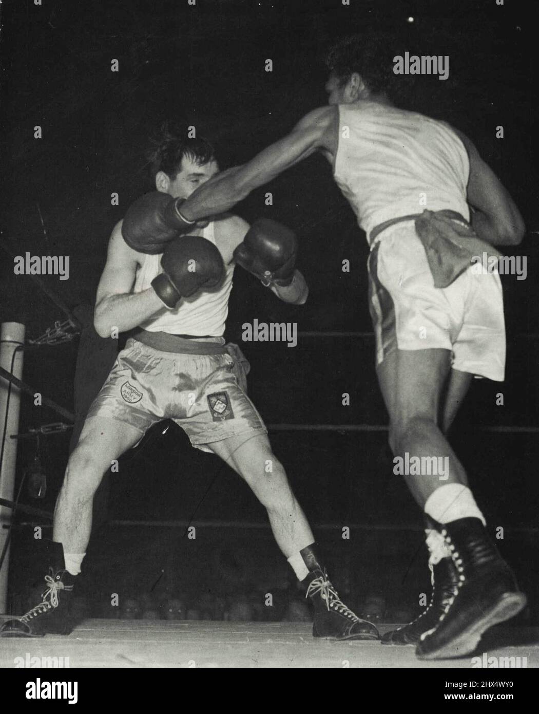 Zweimal in einer Nacht gewonnen - Trinidad - geboren Percy Lewis, britischer Amateur-Federgewichtsmeister, kämpfte vor kurzem zweimal in einer Nacht und gewann beide Male. Er übertraf den Spanier Pineiro in Wernbly, zog einen Track Suit an und stürzte zu Shepherd's Bush, wo er Clem A'Court schlug. Hier landet er eine seiner vielen geraden Linken auf A'Court. 30. November 1952. (Foto von Paul Popper Ltd.). Stockfoto