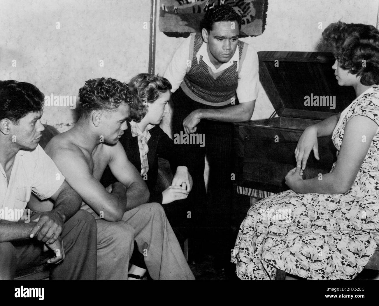 Das Bild unten zeigt angespannte Mitglieder der Sands-Familie, die einer Sendung aus London über den Dave Sands-Tommy Yarosz-Kampf zuhören. Von links: George, Mrs. Dave Sands, Alfie, Clem, Schwester Lily. Sie befinden sich in der Lounge ihres Hauses in Stockton, Newcastle. Nicht einmal das Flimmern eines Augenlids offenbarte Emotionen, als sie dem Kampf zuhörten. Als es vorbei war. Daves Frau sagte: 'Dave hat sein Bestes gegeben. Es ist alles im Spiel.“ 5. April 1949. Stockfoto