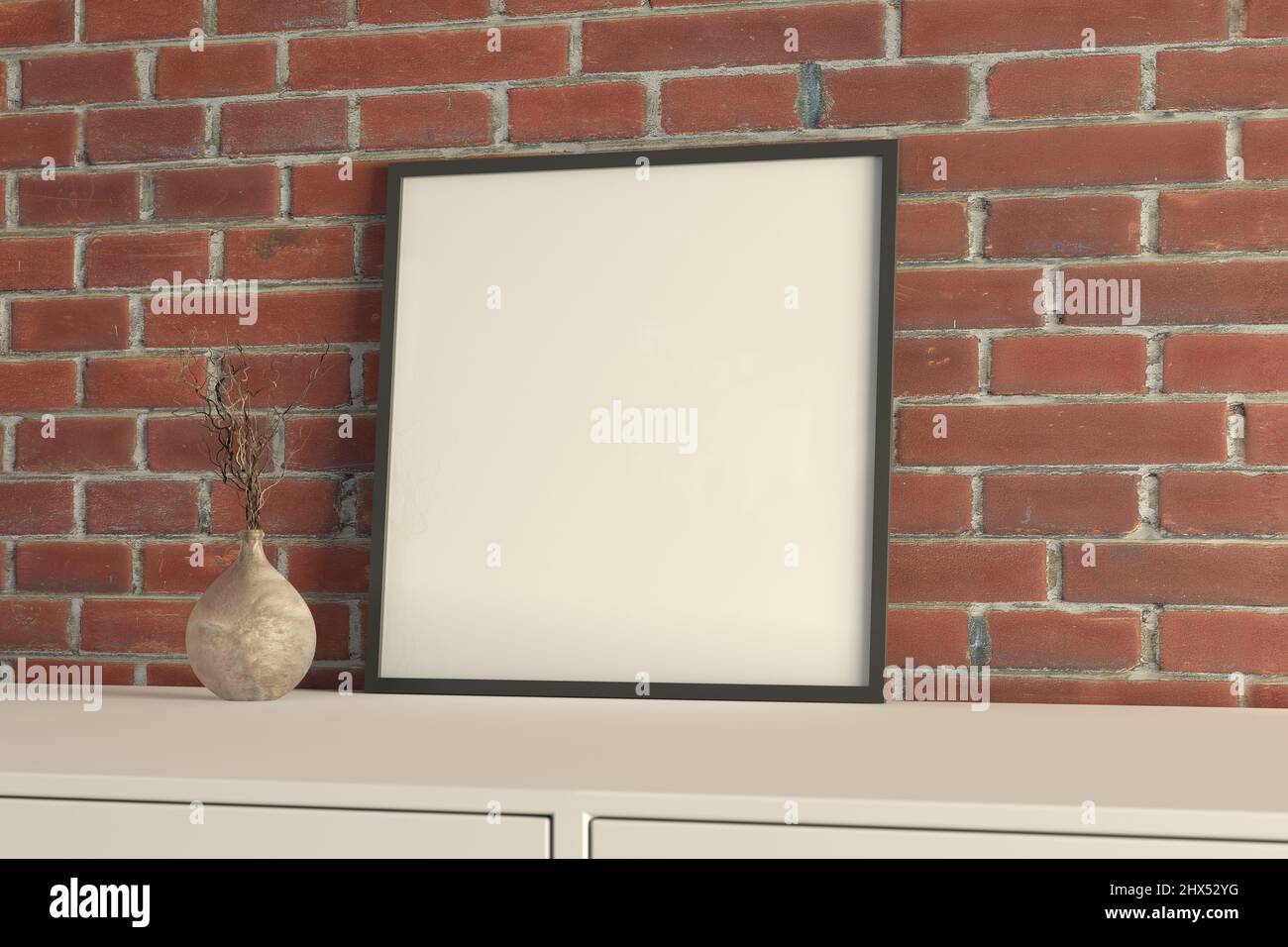 Poster mit quadratischem Rahmen auf dem weißen Tisch mit roter Backsteinwand auf dem Hintergrund Stockfoto