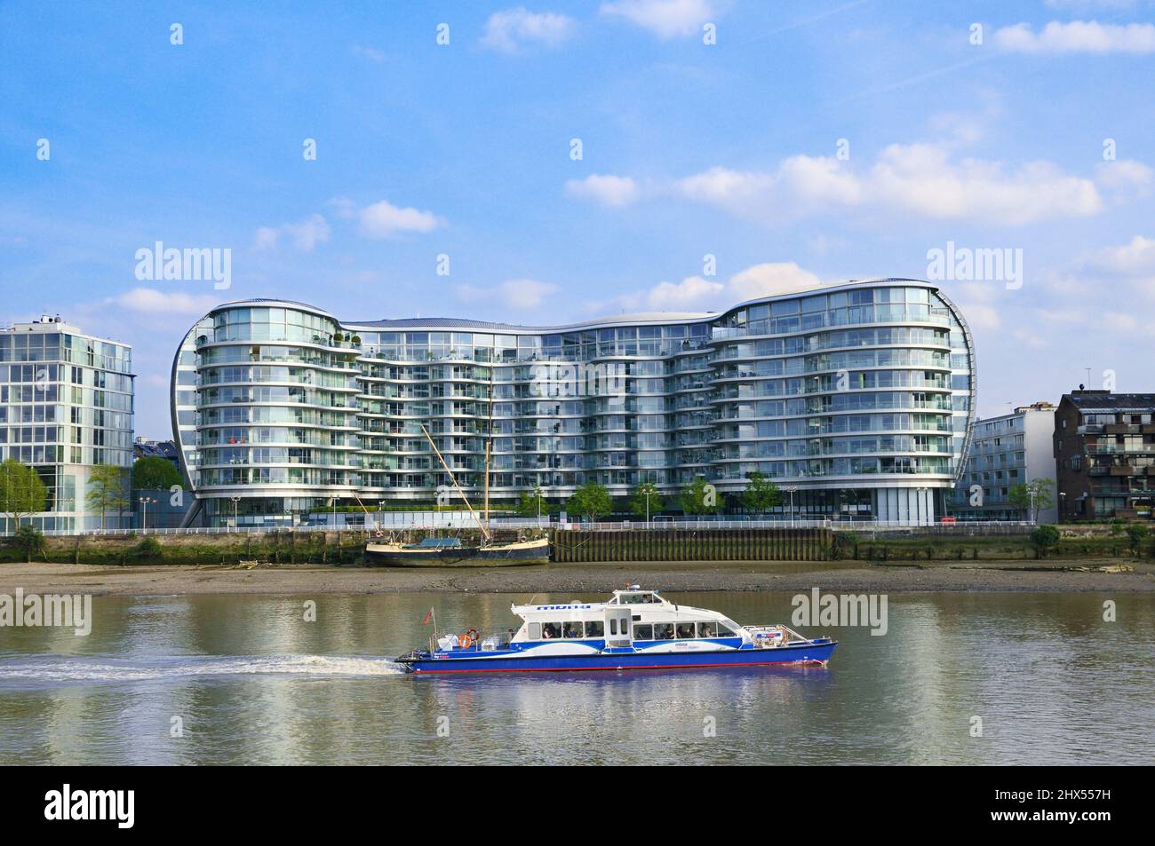 Ein Boot der Thames Clipper fährt am Albion Riverside Gebäude über die Themse in Battersea, London, England, Großbritannien, vorbei. Architekt: Foster und Partner Stockfoto