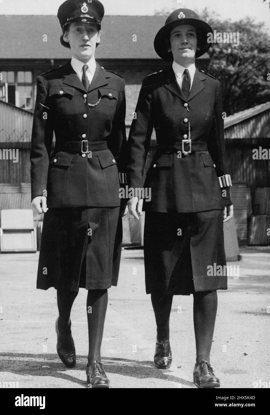 Modellierung Neue Uniform für Polizistinnen die beiden Uniformen bei New Scotland Yard, London (links heute, 23. Juli). Das neue Outfit ist auf ***** Und der aktuelle Typ rechts. Irgendwann im November wird eine neue Uniform für Polizistinnen herausgegeben. Diese Uniform wurde sowohl im Winter als auch im Sommer entworfen, wo als Polizistinnen bis heute Sommer- und Winteruniformen ausgestellt wurden. Sie ist aus Barathea gefertigt und die Tunika ist in Schnitt und Design verbessert, mit gepolsterten Schultern und zwei aufgesetzten oberen Taschen. Ein neuer 6-Plisseedrock wurde so entworfen, dass er besser hängt. 23. Juli 1946. (Foto Stockfoto