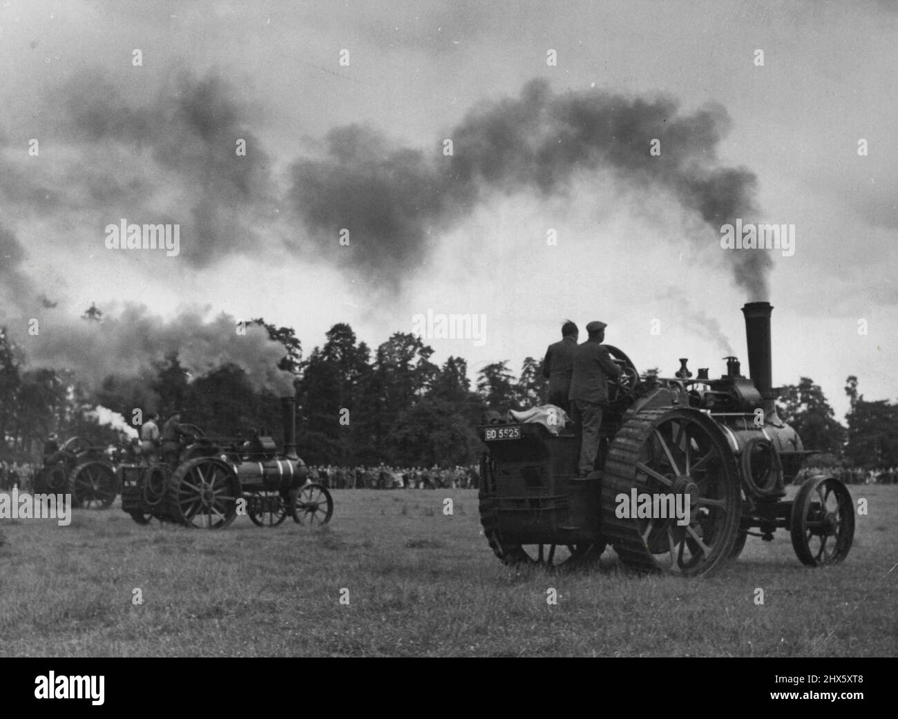 Das Traction-Engine Derby - Es ist Derby Day für fünf ... „Sie sind weg.“ Lady Grove, im Besitz und gefahren von Ex-Jagdflieger Miles Chetwynd-Stapylton, 31, eilt in die Führung, nur um verfolgt zu werden, nein, wurde von Old Timer überholt, der schließlich das Milerennen auf der Wiese des Bauern Arthur Napper in Appleford, Berks, gewann. Zweite Zuschauer und zwei Buchmacher beobachteten dieses Rennen um die Triebwerke, das ein jährliches Ereignis ist. 09. Juni 1952. (Foto von Mirror Pic).;The Traction-Engine Derby - IT's Stockfoto