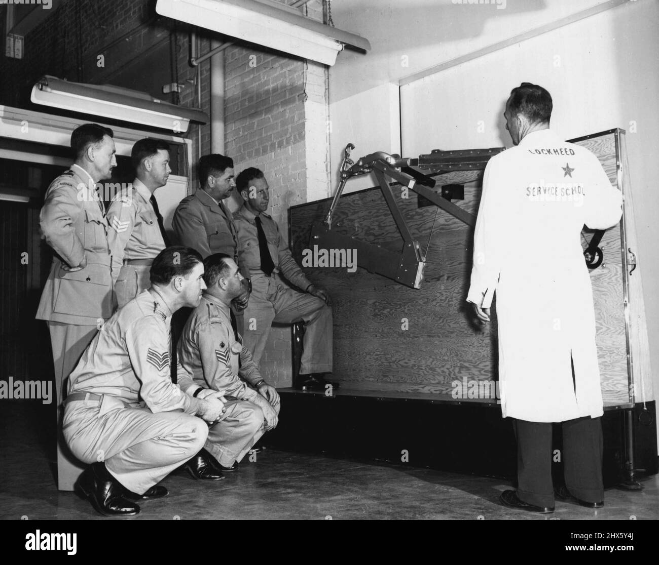 RAAP Maintenance Superintendents studieren Modelle von P2V Systemen in der Außendienstschule von Lockheed, um sich auf den Tag vorzubereiten, an dem die Langstreckenflugzeuge gegen U-Boot in den Dienst Australiens treten. Während RAAF-Piloten und -Navigatoren in der Flugtrainingsabteilung von Lockheed studieren, besuchen diese Wartungsleiter Kurse an der Außendienstschule von Lockheed. Je nach Aufgabenstellung melden sich die RAAF-Männer für spezielle Kurse an. Die Crew-Chefs werden mit der operativen Wartung des E vertraut Stockfoto