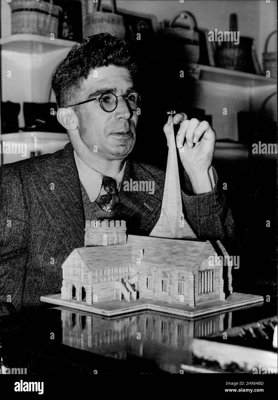 Gebrauchte Matches Helfen Sie ihm, seinen Lebensunterhalt zu verdienen -- Matchsticks verdienen Geld an den 30-jährigen William Brenchley aus Newhaven, Sussex. Er verwendet sie, um Modelle wie das von Chailey Church, Sussex, zu bauen, an dem er hier im Newhaven Searchlight Cripples' Workshop arbeitet. Herr Brenchley, der nicht gehen kann und nur teilweise seine Arme benutzt, verbringt die meiste Zeit in der Werkstatt beim Weben und Korbbau. Er begann mit Matchstick-Modeln als Hobby, findet es aber jetzt als ein nützliches Teilzeitgeschäft mit eno Stockfoto