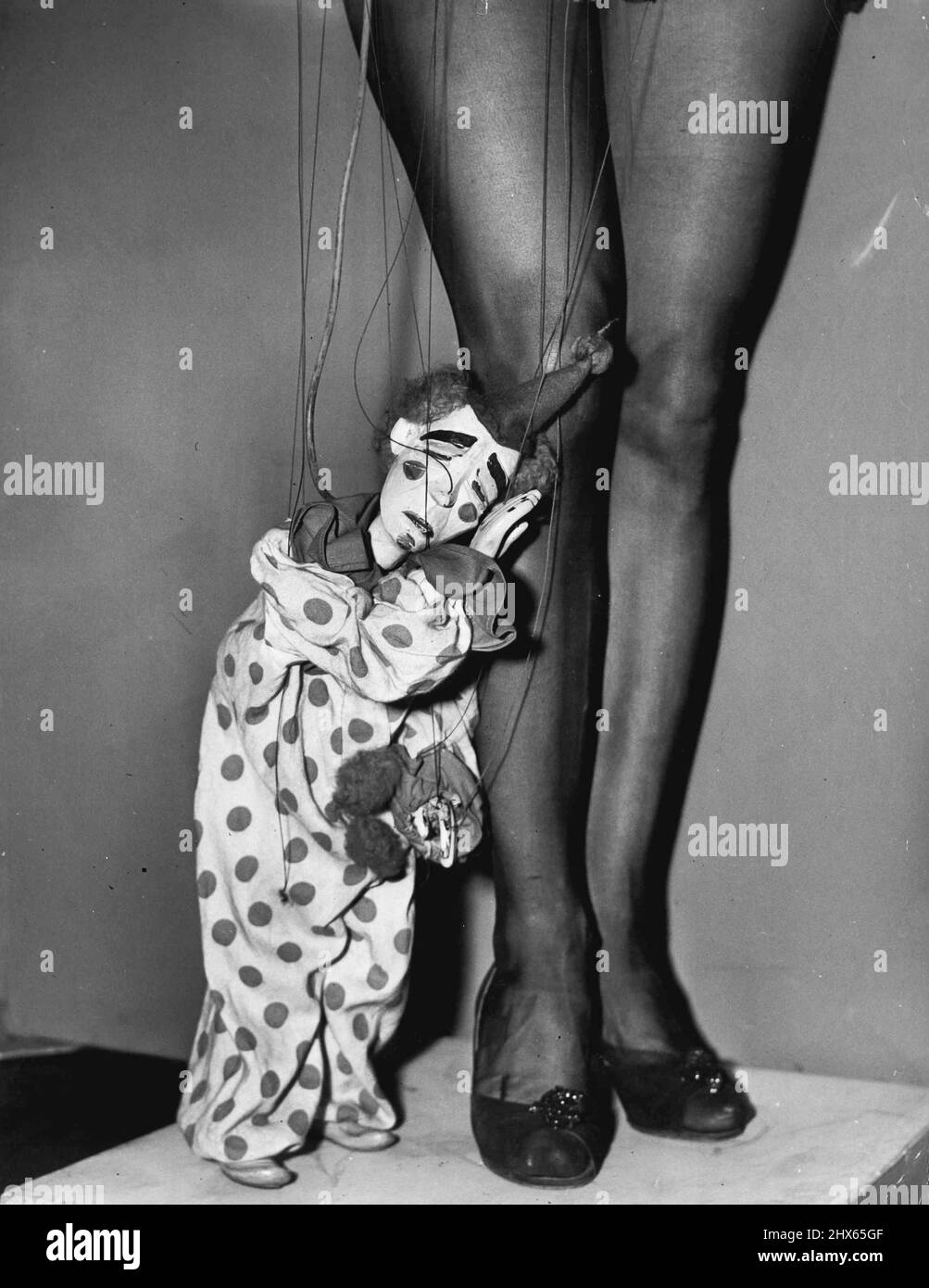 Bimbo, der Clown (oben), ist nicht glücklich darüber, so klein zu sein, wenn er nur größer wäre, könnte er seinen Chef erreichen, Ronnie Eliot - das sind Ronnie Legs auf dem Bild Miss Elliots Marionetten werden am kommenden Sonntag im Wettbewerb von Bondi sein - Hilfe des Royal Prince Alfred Hospital. Bimbo, der Clown (oben), ist nicht glücklich darüber, so klein zu sein, oder vielleicht ist er wund, wenn er einen Job mit zu vielen Fäden hat. Was immer es ist, wird er Schwierigkeiten haben, diesem Boss, Ronnie Eliot, ins Ohr zu flüstern (ihr gehört das le Stockfoto