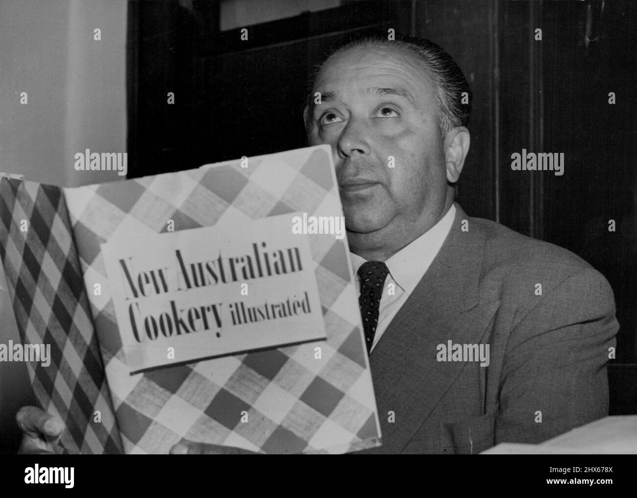 Carlos Zalapa, brasilianisches Konsulat, liest sich das New Australian Coospicy Buch durch und gibt seine Zustimmung, er ist eine kommission ***** Von Lebensmitteln. 07. Dezember 1950. Stockfoto