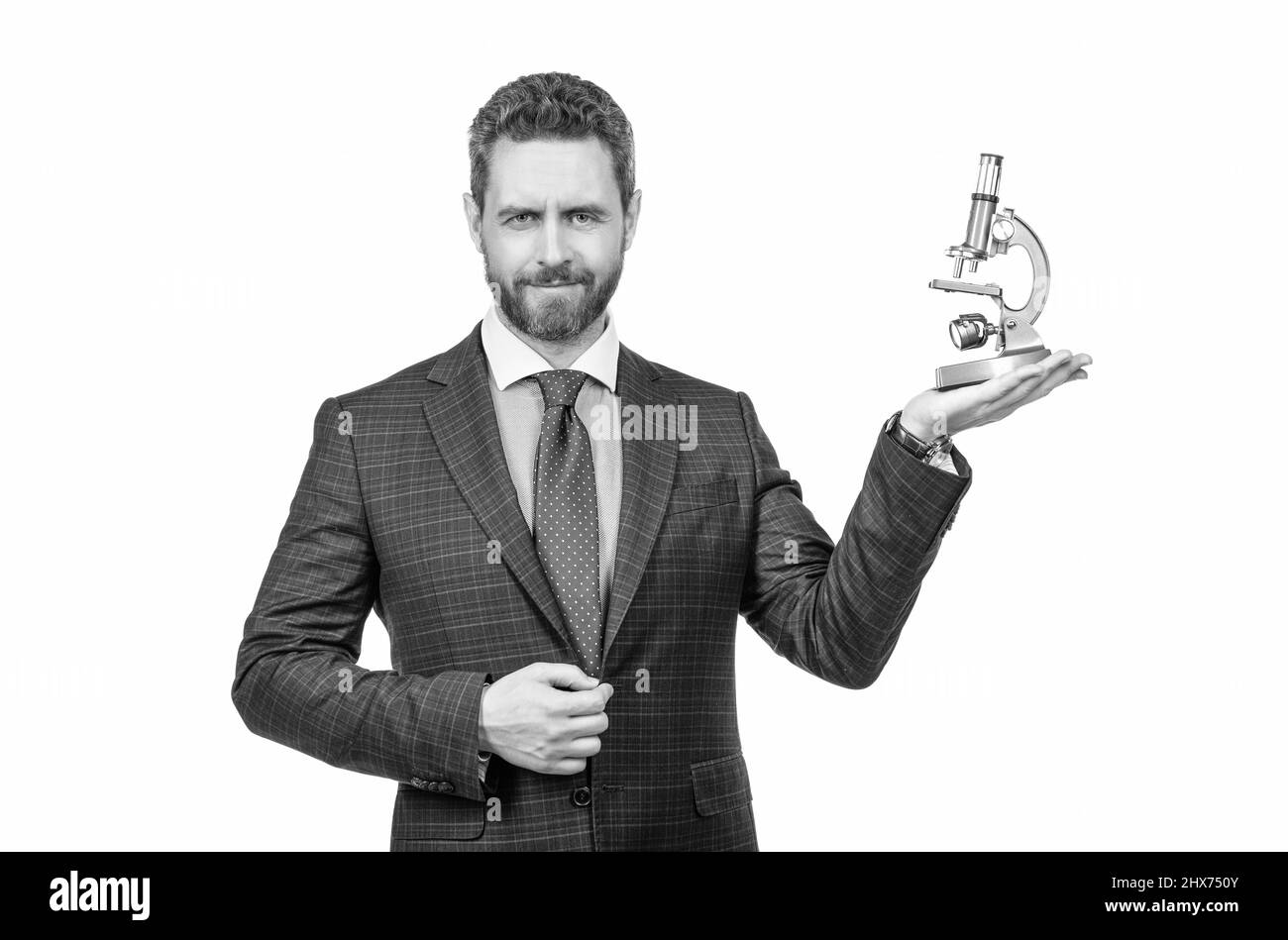 Schöner Geschäftsmann Mann in Anzug präsentiert moderne Mikroskop isoliert auf weiß, Research Investor. Stockfoto