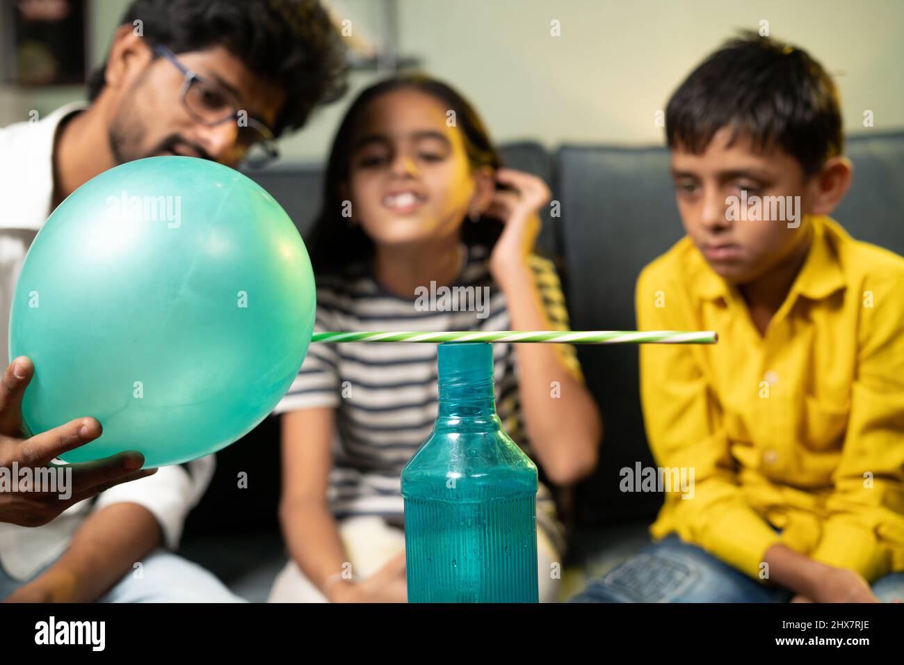 Kinder zu Hause in aufgeregt beobachten satte Klammern oder statische elektrische Wissenschaft Experiment zu Hause, indem sie zeigen Bleistift anzieht, um Ballon - Konzept der Stockfoto
