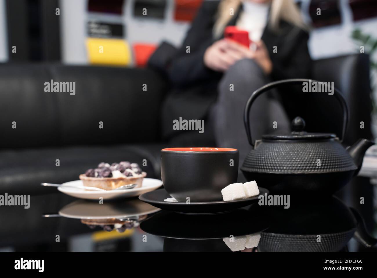 Teepaar und Teekannen auf einem schwarzen Glastisch. Nahaufnahme. Stockfoto