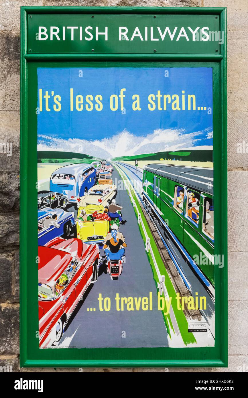 England, Dorset, Isle of Purbeck, Corfe Castle, The Historic Railway Station, Vintage Railway Poster Advertising The Advantage of Travelling by Train over Road Travel Stockfoto