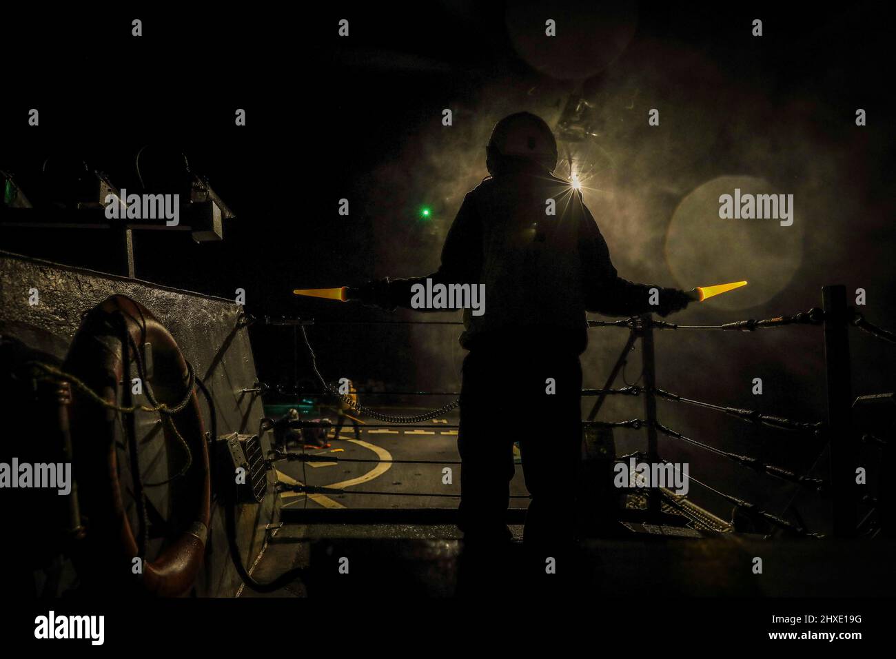 Atlantischer Ozean. 8. März 2022. Ein Seemann, der dem Arleigh Burke-Klasse Lenkraketen-Zerstörer USS the Sullivans (DDG 68) zugewiesen wurde, unterstützt bei abendlichen Gefechtsoperationen auf dem Flugdeck des Schiffes, März 3. Die Sullivans werden im europäischen Operationssaal eingesetzt und nehmen an einer Reihe von maritimen Aktivitäten zur Unterstützung der Sechsten Flotte der USA und der NATO-Alliierten Teil.Quelle: U.S. Navy/ZUMA Press Wire Service/ZUMAPRESS.com/Alamy Live News Stockfoto