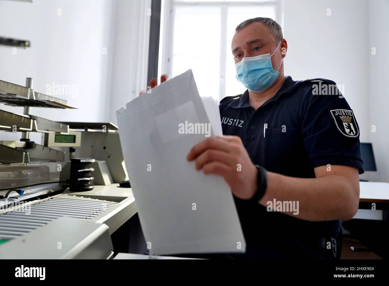 Berlin, Deutschland. 15.. Februar 2022. Patrick Jaeke, Chief Constable, scannt die im Postraum erhaltenen Dokumente zur digitalen Erfassung. Deutschlands größtes Sozialgericht betreibt einen Hörsaal, der vollständig für die elektronische Aufbewahrung von Aufzeichnungen ausgestattet ist. (To dpa-KORR 'Scanner und Monitore statt Dateien - ein langer Weg für die Justiz') Quelle: Carsten Koall/dpa/Alamy Live News Stockfoto