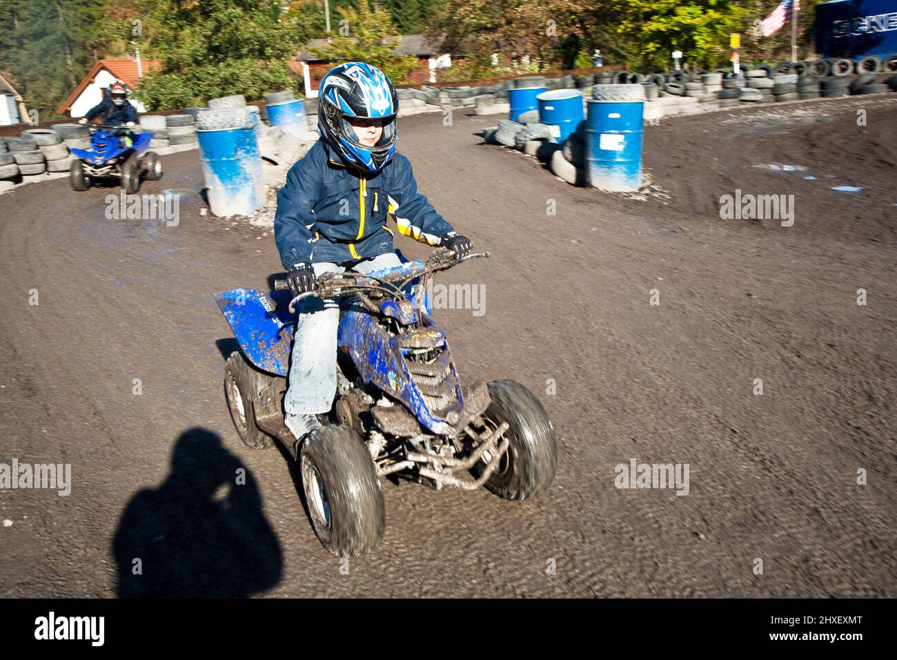 Kind liebt zu Rennen mit einem Quad Bike am schlammigen Quad-strecke Stockfoto