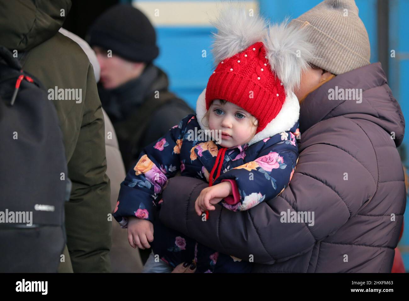 LVIV, UKRAINE - 11. MÄRZ 2022 - Ein kleines Mädchen wird abgebildet, während Menschen, die vor der russischen Invasion fliehen, auf einen Evakuierungszug nach Przemysl, Polen, warten Stockfoto