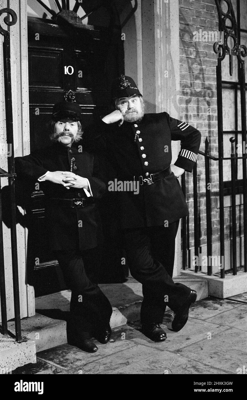 Ronnie Corbett und Ronnie Barker verkleidet als Polizisten im Dienst vor der Downing Street 10 während der Dreharbeiten zu einem ihrer Skizzen in den BBC Studios in Ealing, West London für die beiden Ronnies.20.. Mai 1976. Stockfoto