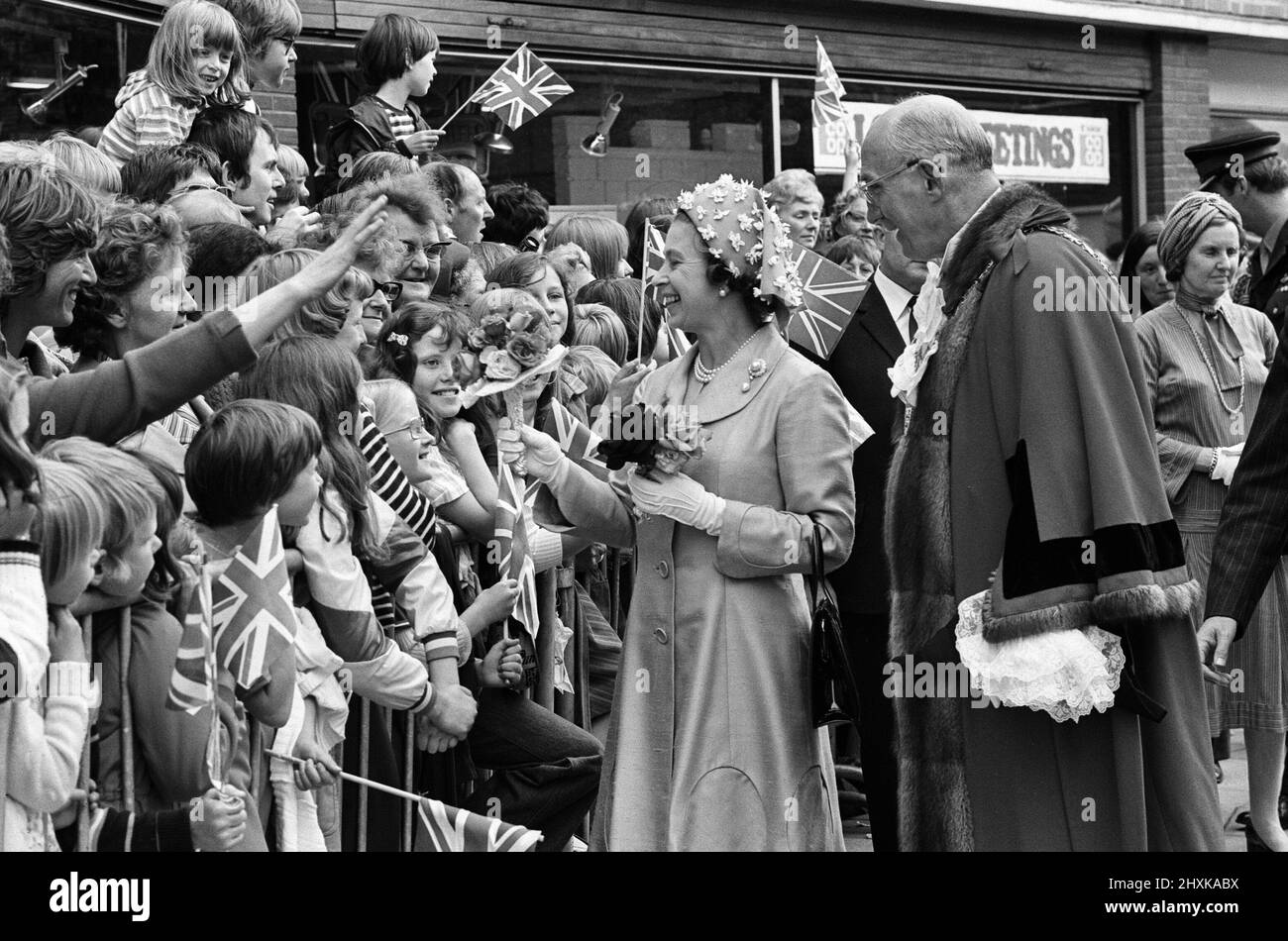 Königin Elizabeth II. Während ihres Besuchs in Solihull, den West Midlands, für ihre Silver Jubilee Tour. Die Königin auf einem Spaziergang auf dem Mell Square, Solihull. Hinter ihr steht der Bürgermeister der Stadt, Stadtrat Norman Green. 27.. Juli 1977. Stockfoto