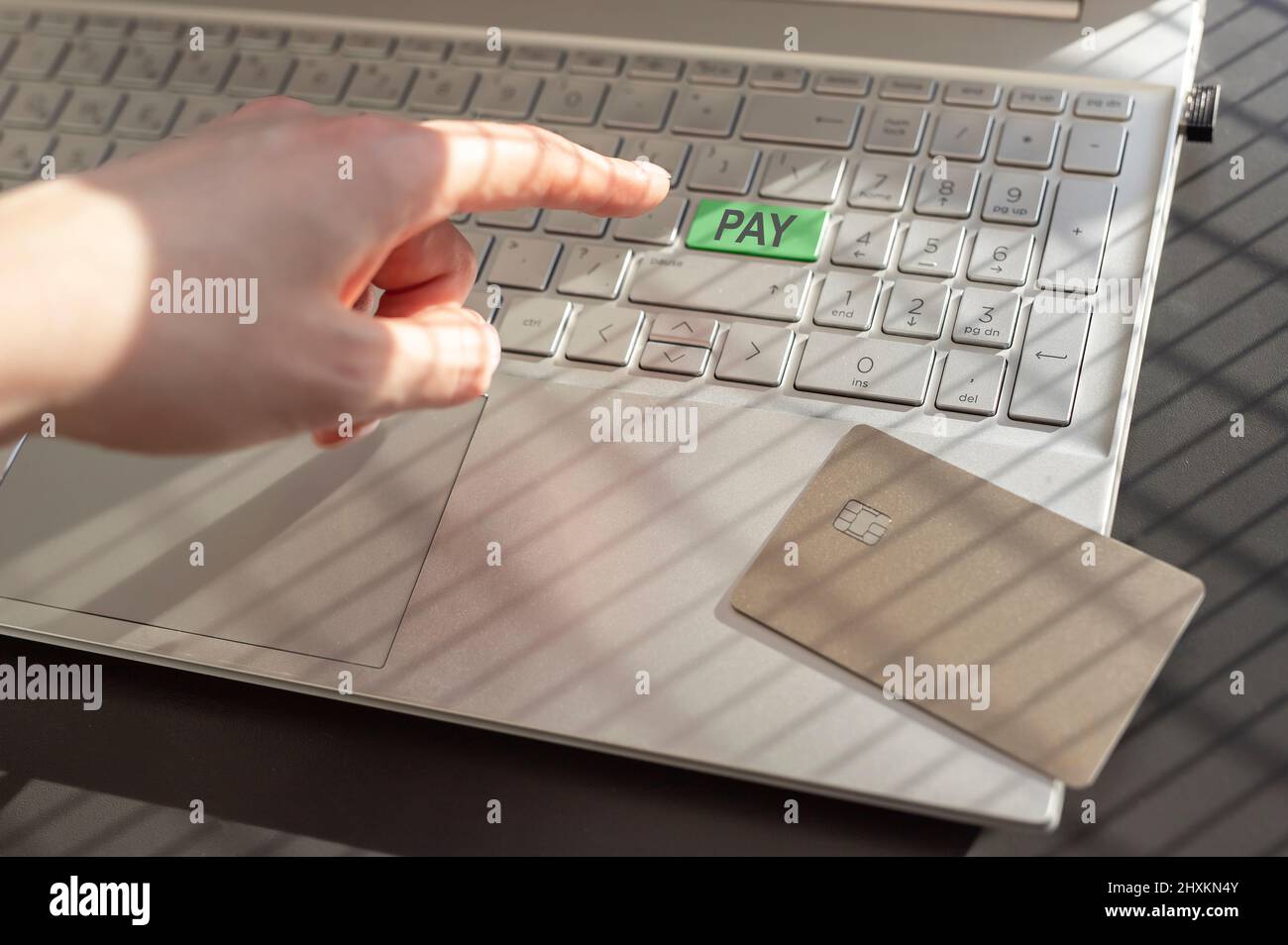 Online-Zahlung concpet. Hand, Finger drücken grüne Safe PAY-Taste, Taste auf Laptop-Tastatur. Stockfoto