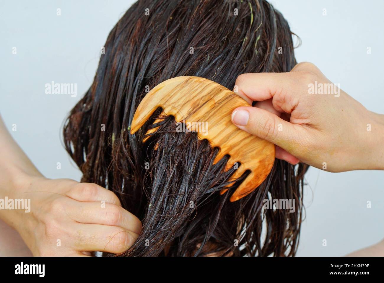 Frau in der Dusche Kämmen Haarbehandlung durch die Haare. Stockfoto