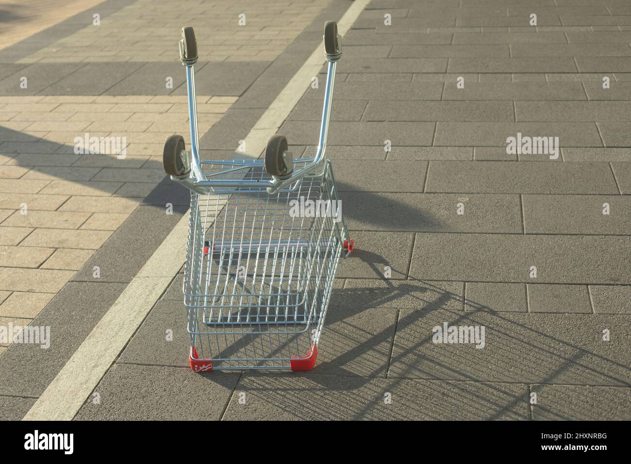 Invertierter Handelskorb. Leerer Verbraucherkorb in Russland. Warenkasten auf Rädern. Lagerort der Produkte. Ein abgebrochener Gegenstand. Konsumgesellschaft Stockfoto