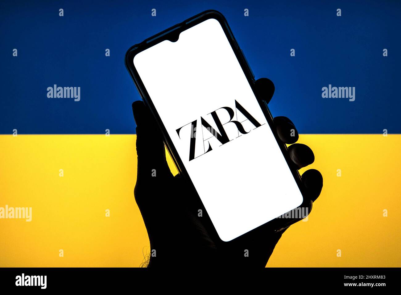 In dieser Abbildung ist ein Zara-Logo auf einem Smartphone mit einer Flagge der Ukraine im Hintergrund zu sehen. Stockfoto