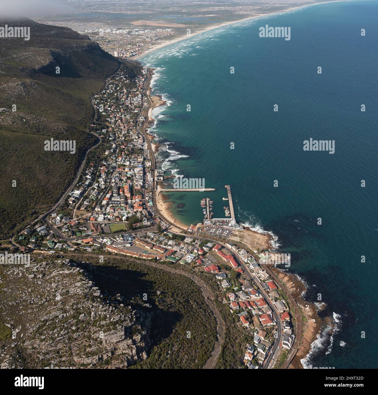 Kalk Bay, Kapstadt, Südafrika. 2022. Luftaufnahme des Fischerhafens und der Stadt an der Uferpromenade von Kalk Bay. Blick entlang der Küste Richtung Muizenberg Stockfoto