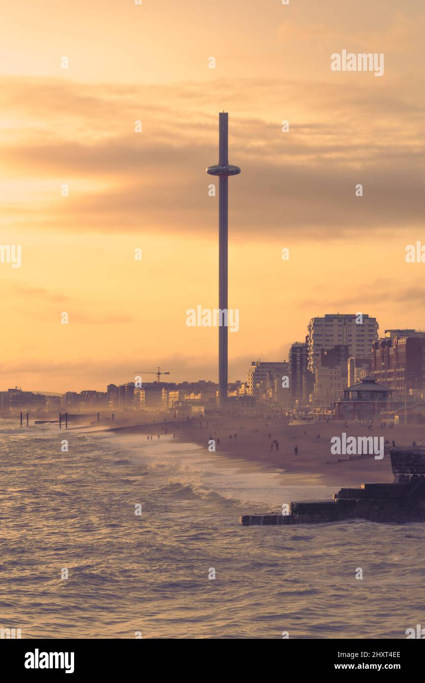 Brighton, East Sussex, England. 13. März 2022. Die Sonne geht an einem frühen Frühlingsabend in Brighton unter, wobei die i360 vom Pier aus über das Meer gesehen werden.©Sarah Mott / Alamy Live News Stockfoto