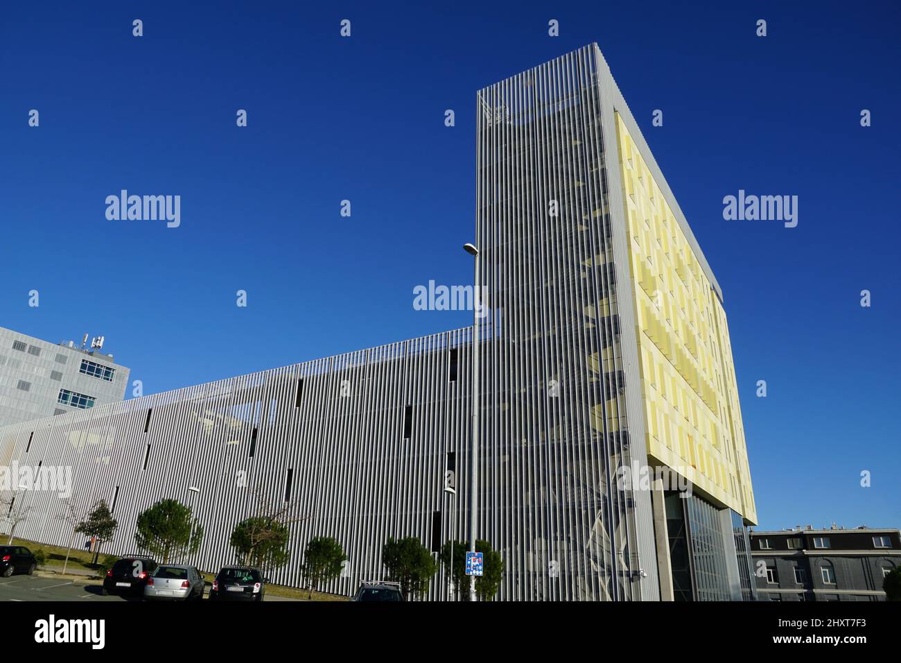 Rijeka, Kroatien, 7.. Februar 2022. Modernes Architekturkonzept mit Seitenblick auf ein großes, gelbes, modernes Gebäude Stockfoto