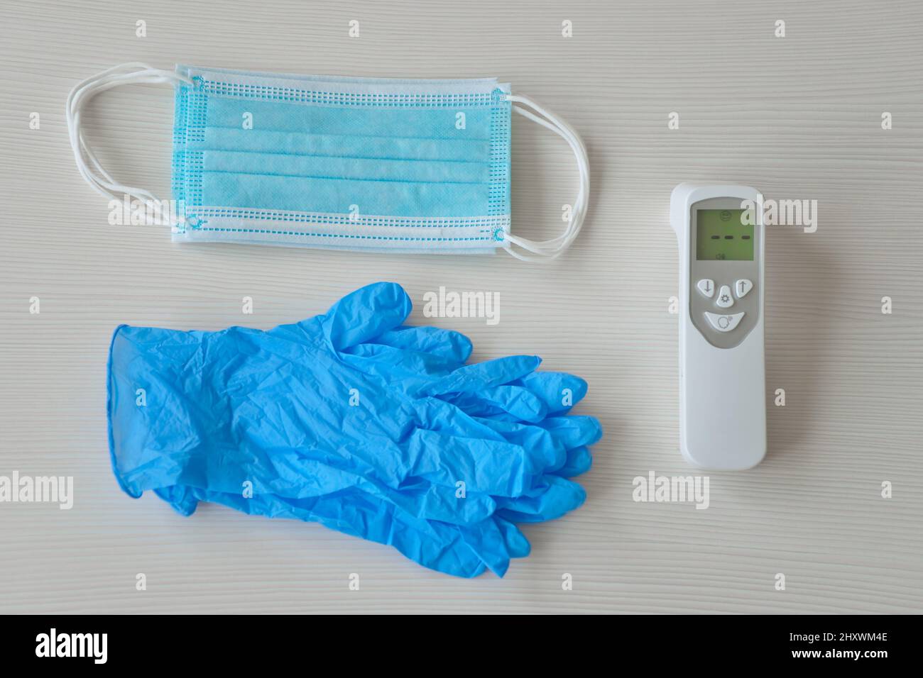 Medizinische Schutzmaske, Gummihandschuhe und Thermometer liegen auf weißem Hintergrund. Anti-Virus-Schutzkit gegen covid-19. Coronavirus-Pandemie 201 Stockfoto