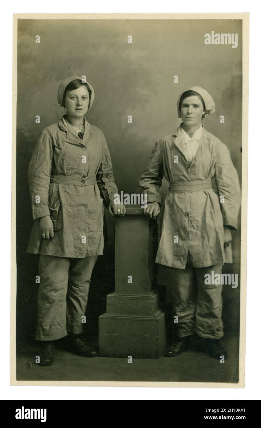 WW1 Ära sehr klar, Postkarte von 2 Munitionsfreunden und -Arbeitern in Uniform, Hosen, Mützen. Die Frauen sind möglicherweise Grinding (Fräsen) House Girls, die in der HM Factory Langwith arbeiten. Die Frauen hier arbeiteten unter gefährlichen Bedingungen an der Herstellung einer Chemikalie namens Ammoniumperchlorat, die hauptsächlich in Meeresminen verwendet wurde und von der Marine verlegt wurde, um deutsche U-Boote davon abzuhalten, Handelsschiffe anzugreifen, die lebenswichtige Lebensmittel und Lieferungen nach Großbritannien brachten. Foto aus dem Studio von J H Waterhouse, Chesterfield, Derbyshire, England, Großbritannien um 1917, 1918. Stockfoto